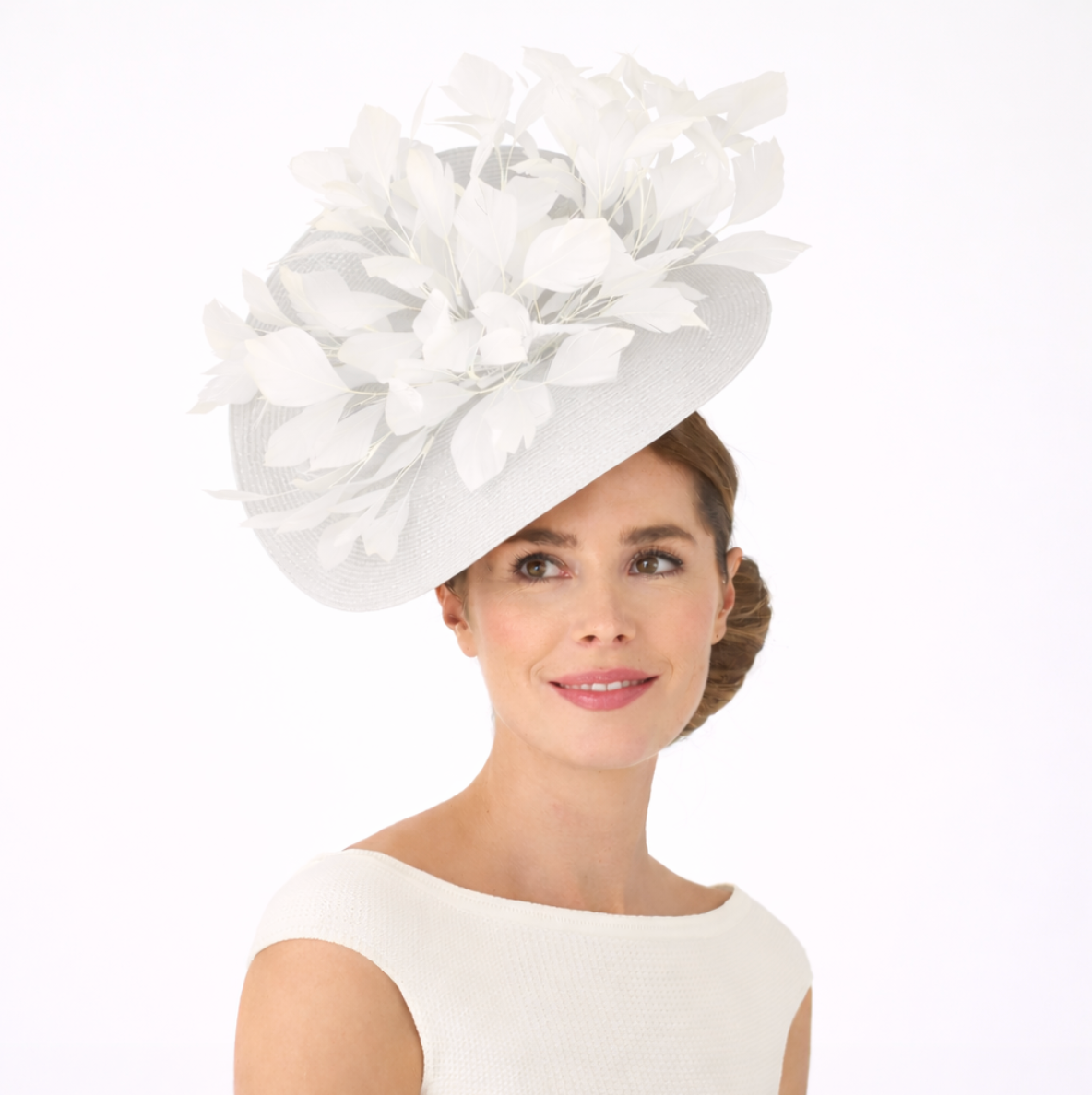 Woman wearing a white decorative hat on a white background