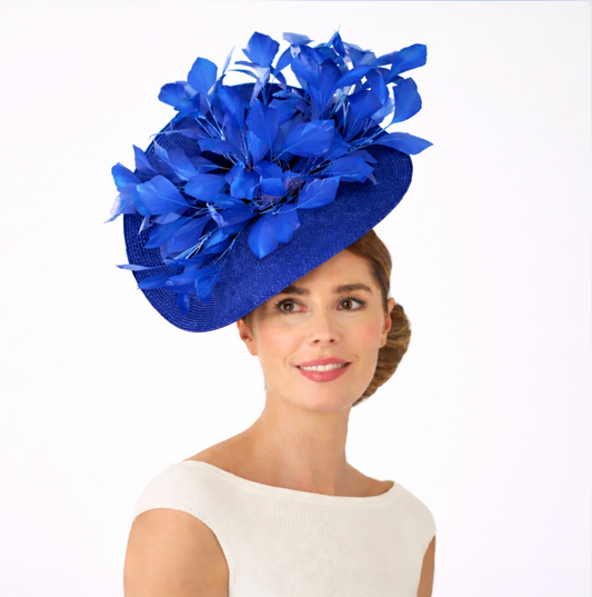 Woman wearing a blue fascinator with floral details on a white background